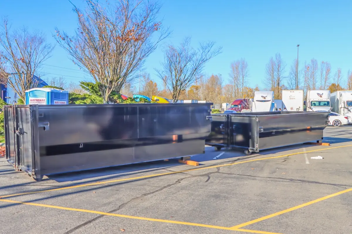 Professional dumpster rental service with roll-off container on residential driveway in Hopkinsville